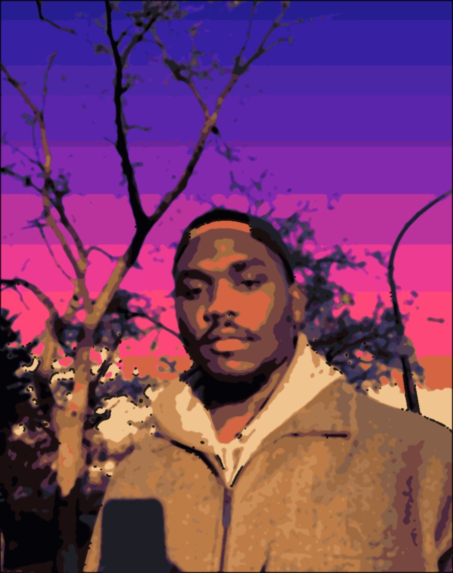 Chiemeka Madufor in a cap and grey jacket under a bare tree in the evening sun